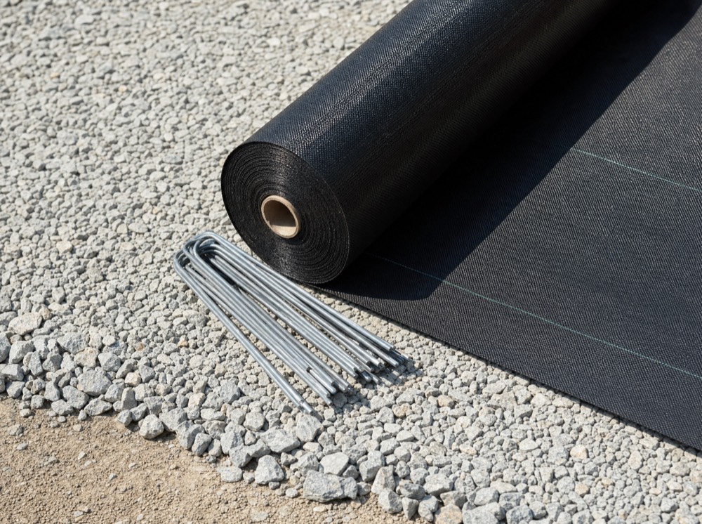 Roll of woven geotextile membrane on a prepared sub-base